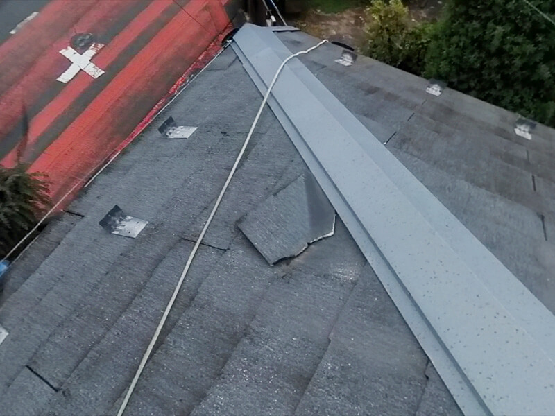 屋根の一部が割れて引っかかっていました。割れた部分をくっつけても落ちてきてしまうため、板金を差し込んで補修します。